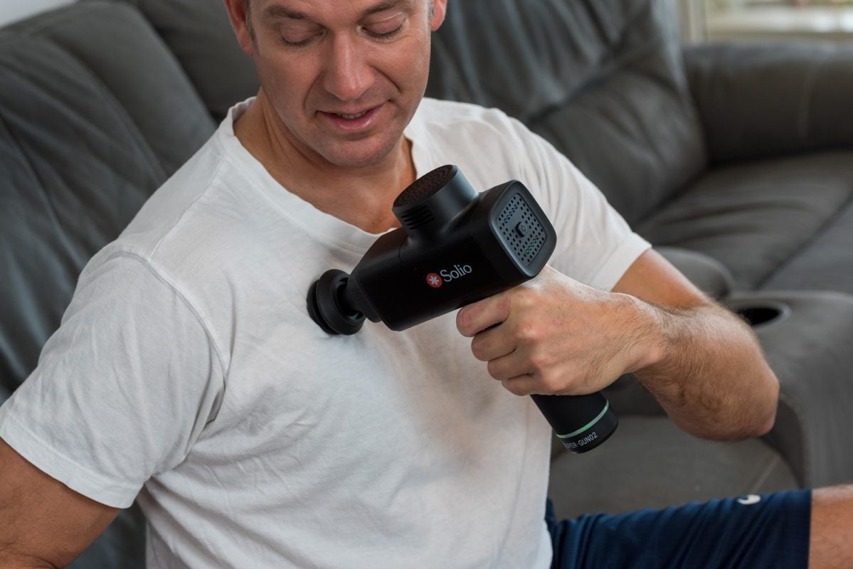 Man performing chest massage with the Solio Super Gun Massager